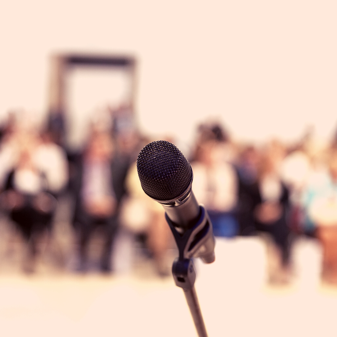 microphone with people faded in the background