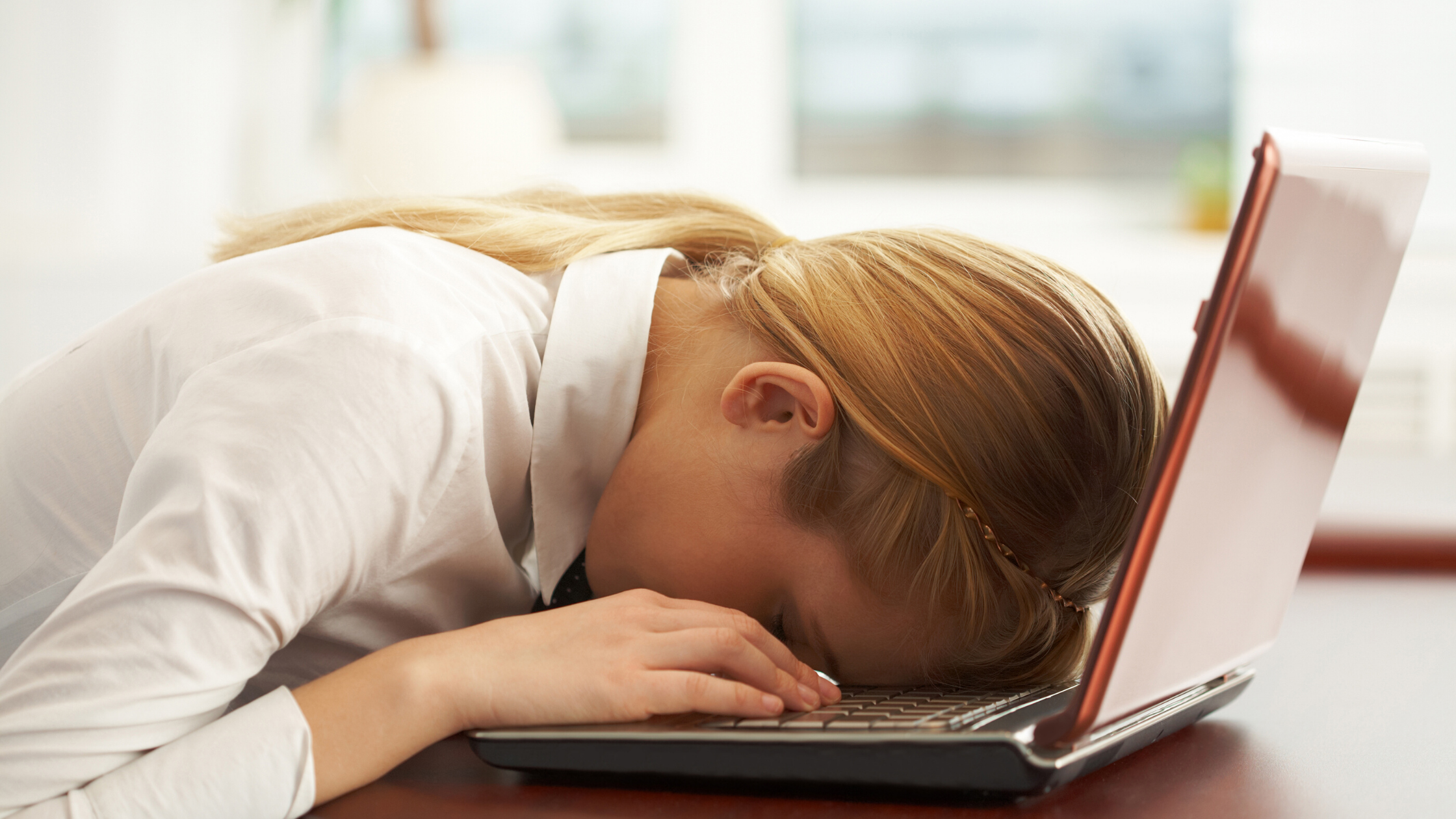 lady with head down on computer