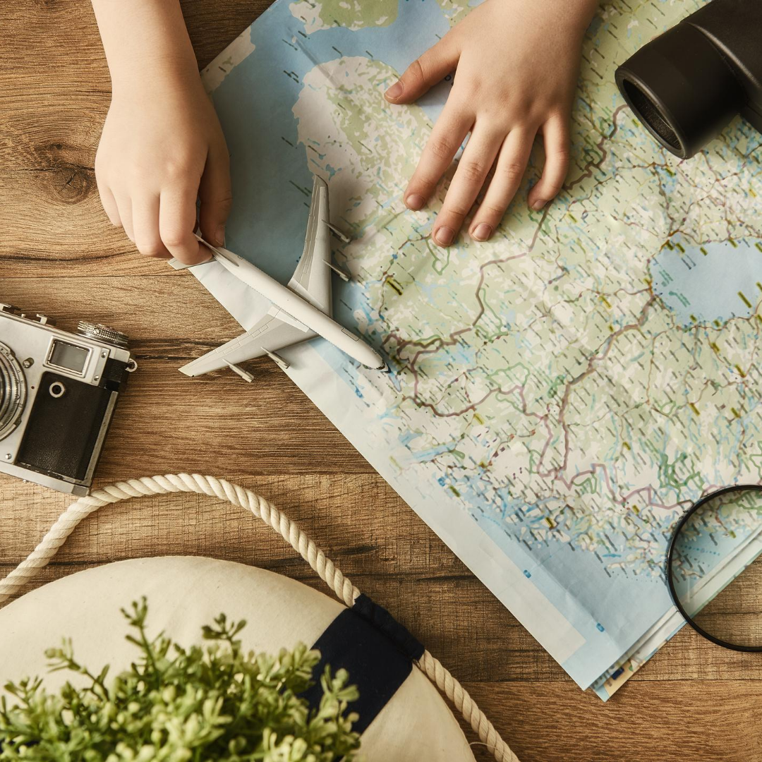 picture of child with map and toy airplane