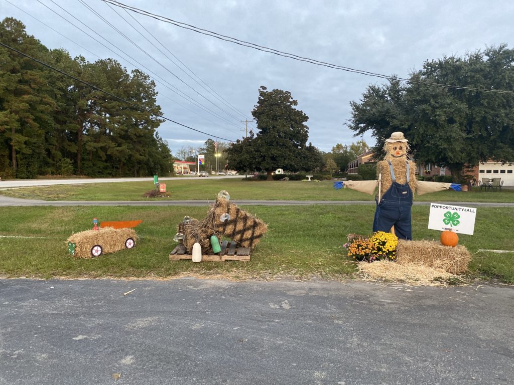 Hay bales made into a car, crab pots, and a scarecrow