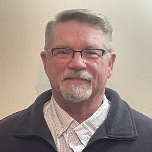 Professional headshot of Mac Prescott, a member of the Pamlico Advisory Council.